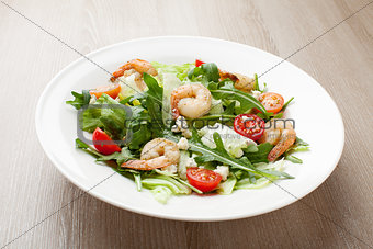 Fresh gourmet seafood salad with shrimps, greens, cherry tomatoe