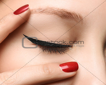 Closed glamour eye make up close with perfect shape black arrow
