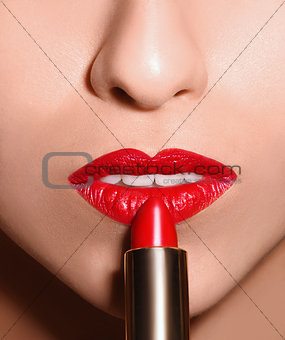 Sensual open mouth  with red tube of lipstick