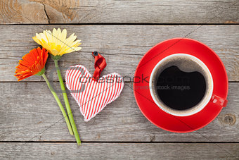 Cup of coffee, heart toy and gerbera flowers