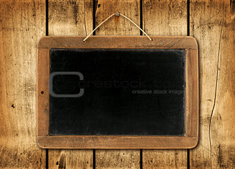 Blackboard on a wood wall background