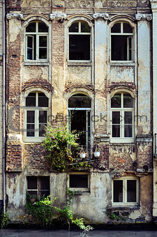 Old weathered wall with vintage windows, Belgium