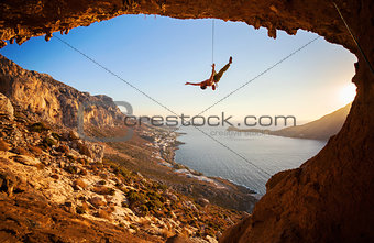 Silhouette of a rock climber falling of a cliff while lead climbing