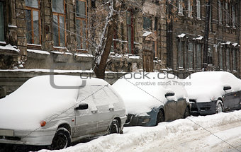 Cars covered with fresh snow