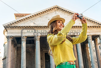 Happy young woman taking photo in front of pantheon in rome, ita