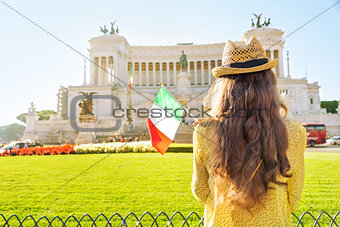 Young woman with italian flag on piazza venezia in rome, italy. 