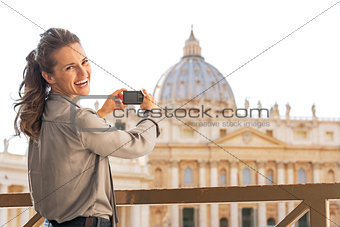 Portrait of happy young woman taking photo of basilica di san pi