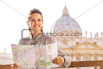 Happy young woman with map on piazza san pietro in vatican city 