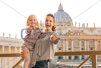 Happy mother and baby girl on piazza san pietro in vatican city 