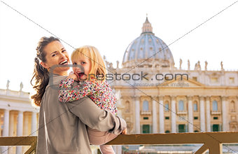 Portrait of happy mother and baby girl in front of basilica di s