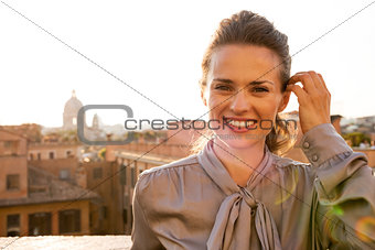 Portrait of happy young woman standing on street overlooking roo