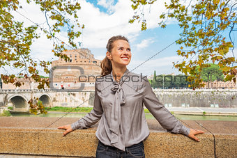 Portrait of happy young woman on embankment near castel sant'ang