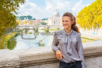 Portrait of happy young woman on bridge with view on basilica di
