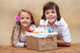Happy kids with easter bunny and colorful eggs