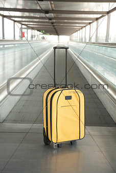 yellow suitcase at walkway