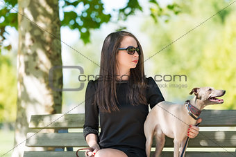 Young girl  with  greyhound in the park
