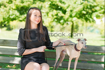 Attractive  girl  with  greyhound in the park