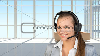 Businesswoman in headset, interior with transparent wall