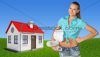 Woman holding hard hat and drawing rolls