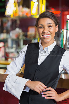 Pretty barmaid smiling at camera