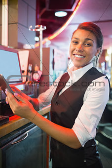 Pretty barmaid using touchscreen till