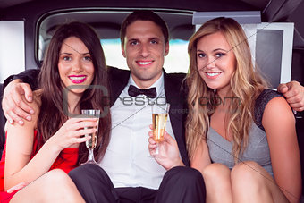 Pretty girls with ladies man in the limousine