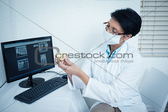 Female dentist holding mouth model