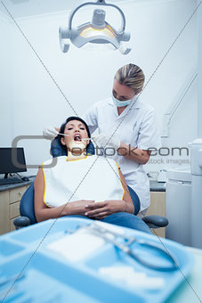 Female dentist examining womans teeth