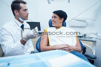 Male dentist examining womans teeth