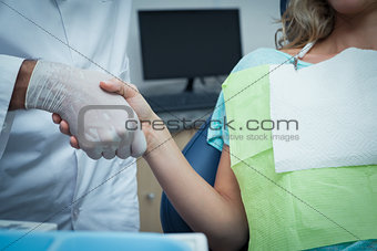 Dentist shaking hands with woman