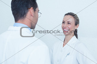Smiling dentists in discussion