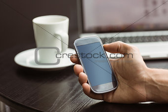 Student holding his mobile phone