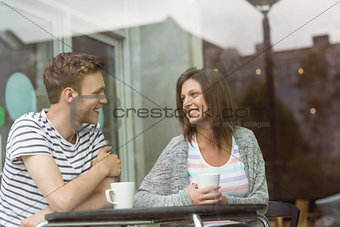Smiling friends with mug of coffee