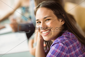 Portrait of a smiling student revising