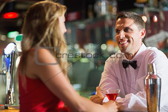 Barman chatting to pretty customer