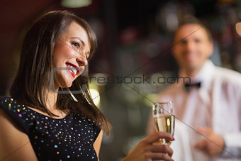 Pretty brunette smiling with champagne