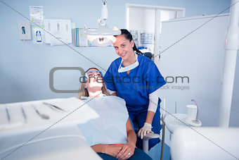 Dentist sitting over patient in the chair