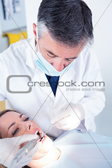 Dentist examining a patients with angled mirror