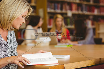 Concentrating mature student studying at desk