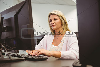 Cheerful mature student using laptop