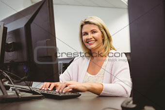 Mature student using laptop looking at camera