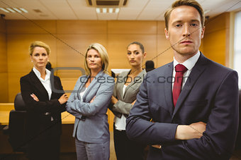Serious lawyer standing with arms crossed