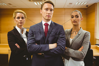 Three serious lawyers standing with arms crossed