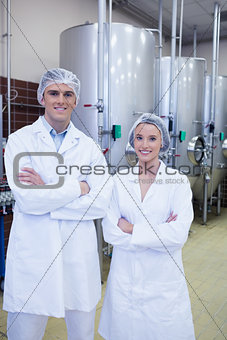 Happy scientists posing with arms crossed