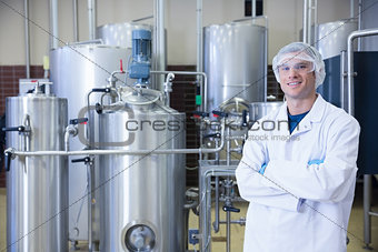 Scientist with arms crossed wearing protective glasses