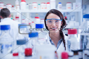 Portrait of a smiling chemist wearing safety glasses