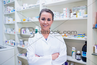 Portrait of a smiling student in lab coat with arms crossed