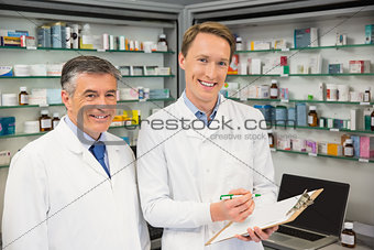 Team of pharmacists looking at clipboard