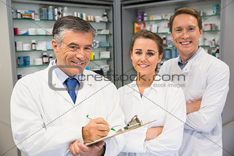 Team of pharmacists smiling at camera