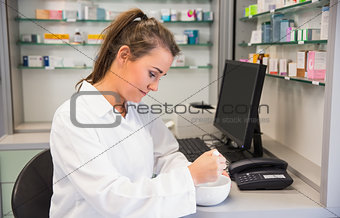 Junior pharmacist mixing a medicine